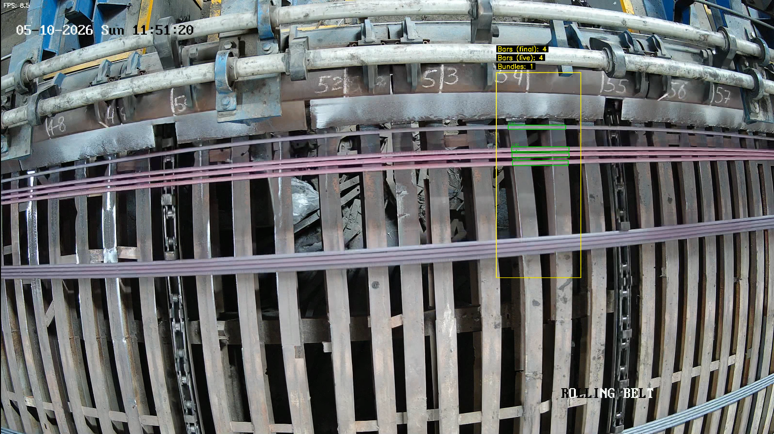 Industrial camera view of reinforcement bars on production equipment with a defined counting area and bar counters.